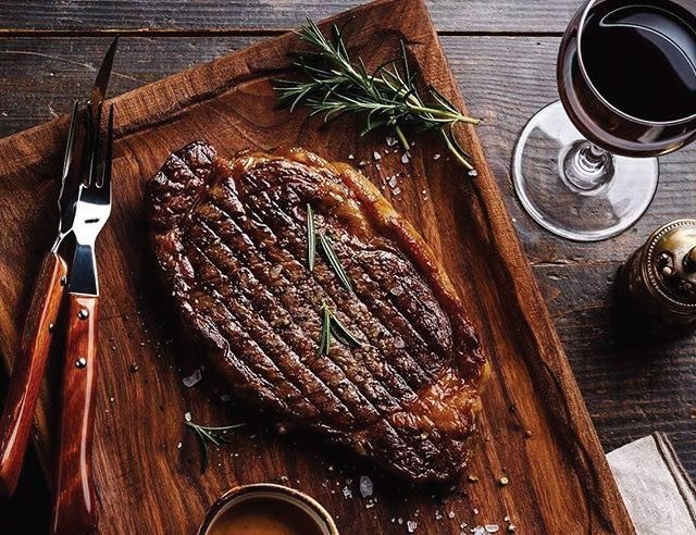 Rib-eye steak on a wooden board